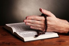 11834959-hands-holding-wooden-rosary-over-open-russian-holy-bible-on-grey-background-w800-h600